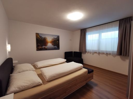 Großzügiges Schlafzimmer mit Doppelbett und viel Tageslicht in der Ferienwohnung SunAlpin im Zillertal